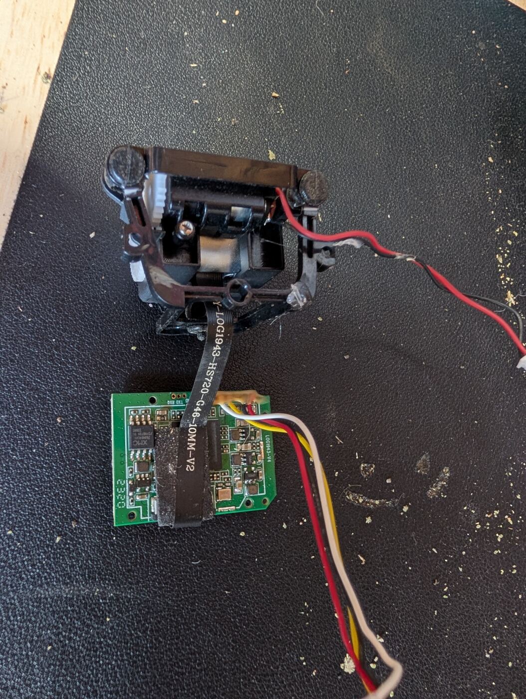 A dead dashcam's gimbal mechanism and camera PCB after teardown